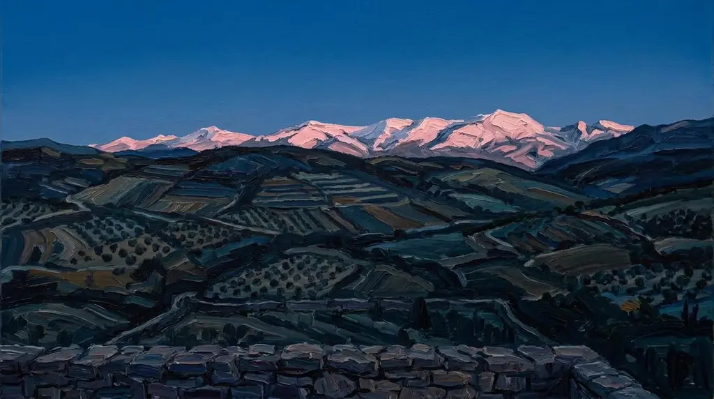 Far snowy mountains glowing rose-pink above dark hills after sunset.